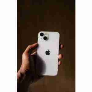 A person holding an iPhone in their hand